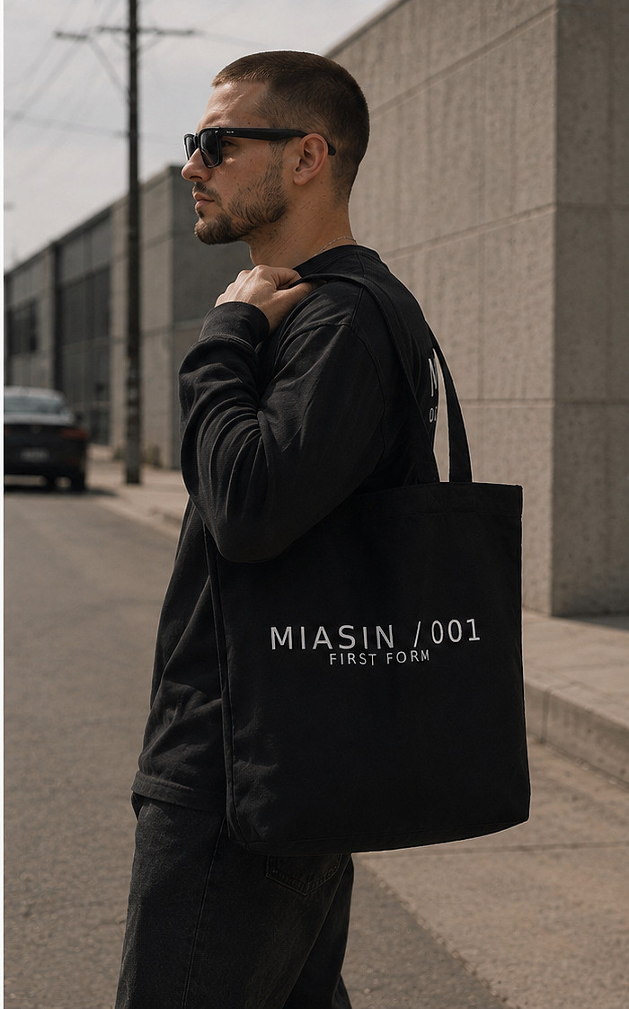A model carrying the black MIASIN 001 canvas tote on a Los Angeles street