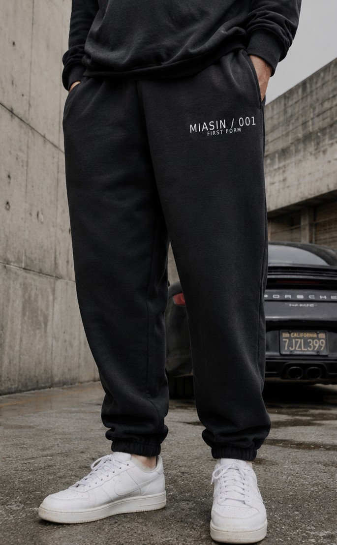 Black MIASIN 001 sweatpants photographed from the waist down